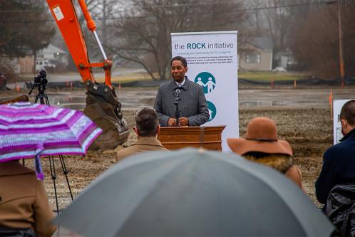 A man speaking at a podium outside during a groundbreaking ceremony