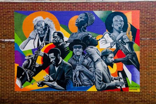 A mural of African American musicians on a brick wall